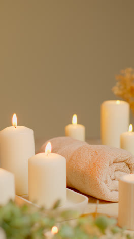 Vertical-Video-Still-Life-Of-Lit-Candles-With-Dried-Grasses-Incense-Stick-And-Soft-Towels-As-Part-Of-Relaxing-Spa-Day-Decor-4